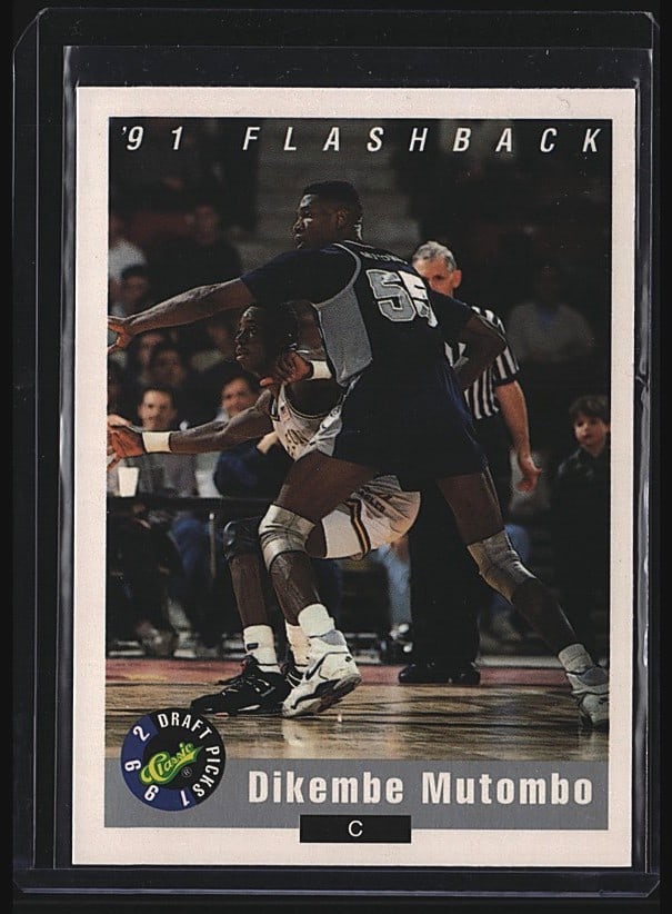 1992 Classic Draft Picks '91 Flashback #98 Dikemb: Raw 1991 Fleer #98 Dikembe Mutombo basketball card. Card features Mutombo in Georgetown uniform mid-game action. Front displays Fleer branding and Flashback label; back includes player statistics and
