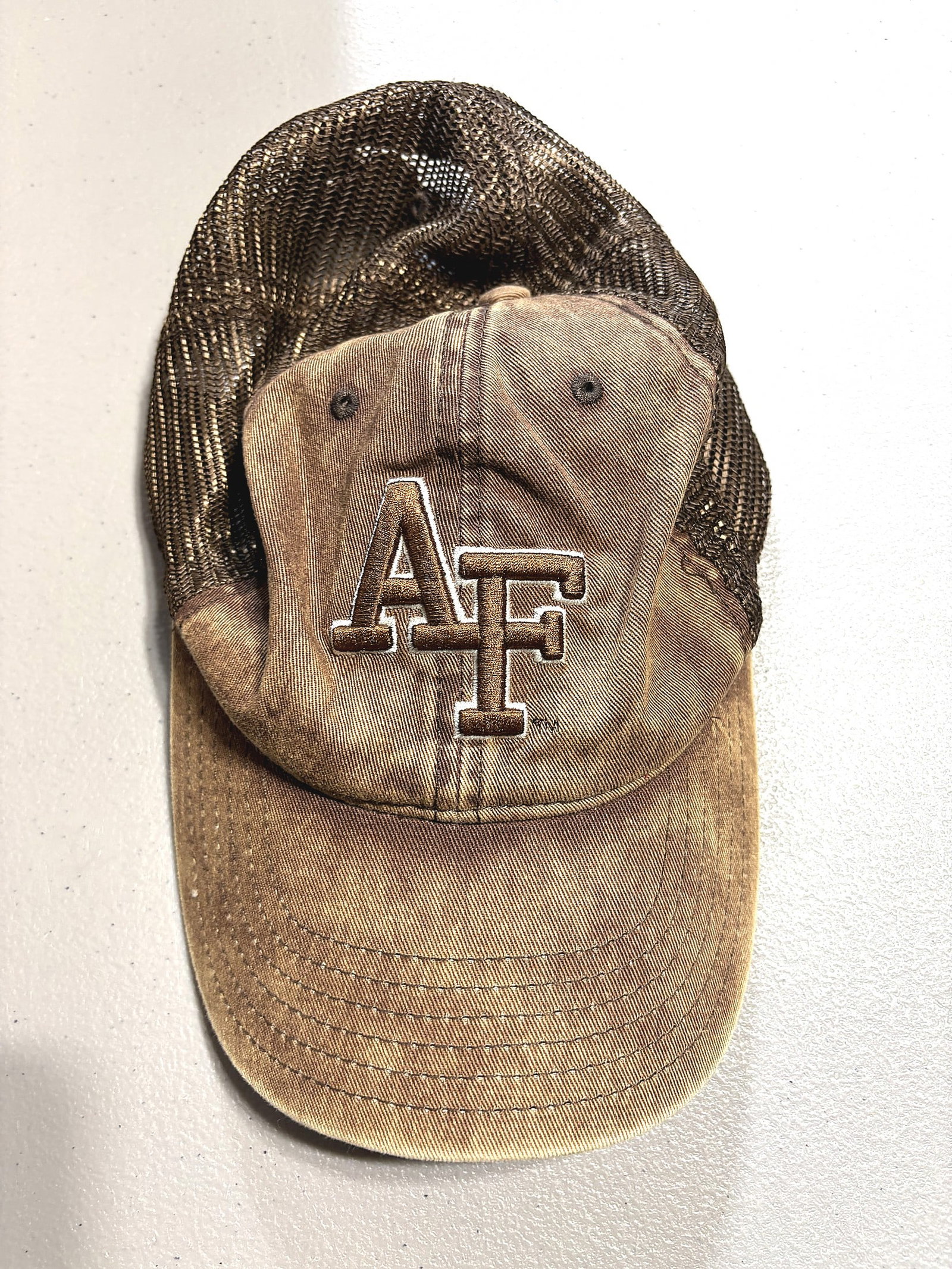 Air Force Falcons AF Trucker Snapback Cap Hat Vin: This is a well-worn Air Force Falcons trucker-style snapback cap featuring embroidered 'AF' initials on the front panel in a bold collegiate font with white outline stitching. The front panels are