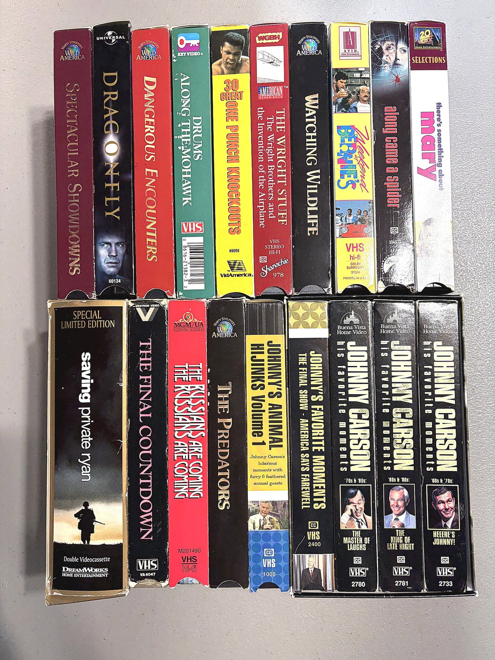 Lot of 18 VHS Tapes Movies TV Specials Johnny Car: This lot includes 18 VHS tapes spanning movies, nature documentaries, and TV specials. Titles visible include Saving Private Ryan (DreamWorks, Special Limited Edition double cassette), Dragonfly (Univ