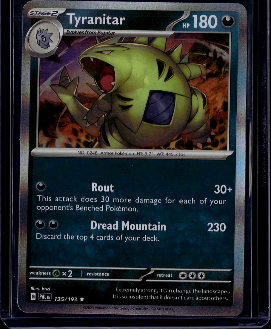 2023 Pokemon Paldea Evolved Tyranitar 135 Near Mi: This is a Tyranitar Stage 2 Pokemon card from the Scarlet & Violet set, card number 135/193. Tyranitar is an Armor Pokemon that evolves from Pupitar and features 180 HP. The card showcases two attacks
