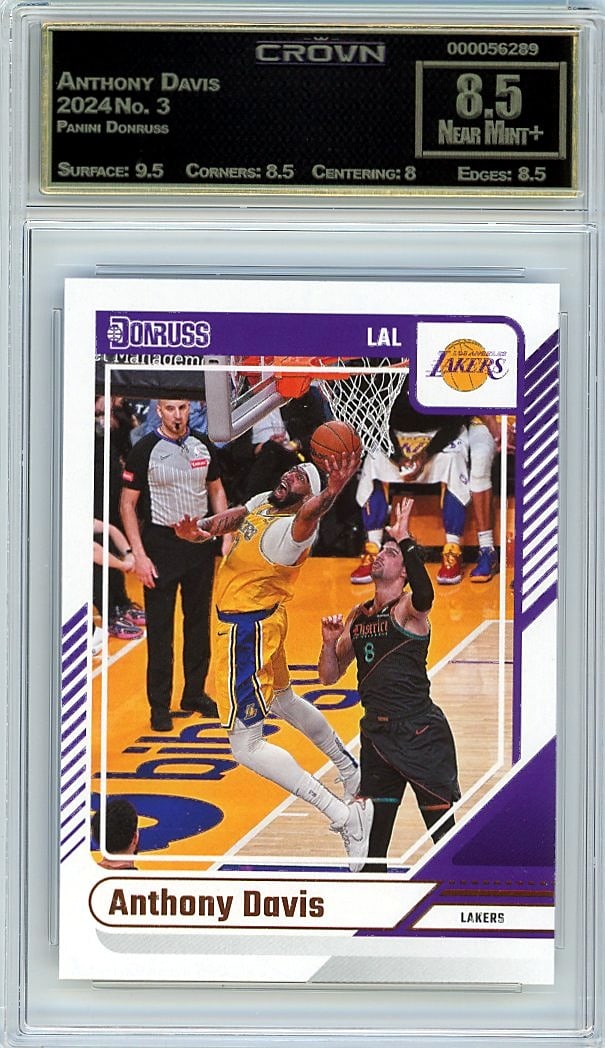 2024 Panini Donruss Anthony Davis #3 Crown 8.5 Gr: This is a 2024 Panini Donruss Anthony Davis card #3, professionally graded and authenticated by Crown at 8.5. The card captures one of the NBA's premier two-way players in Panini's classic Donruss