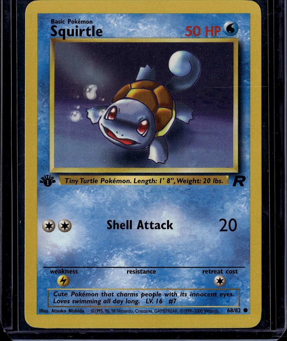 Squirtle 68/82 Base Set Pokemon Card 1999 - Class: This is an authentic Base Set Squirtle Pokemon trading card from 1999, featuring the iconic "Tiny Turtle Pokemon" artwork by Atsuko Nishida. Card #68/82 showcases Squirtle's "Shell Attack" move
