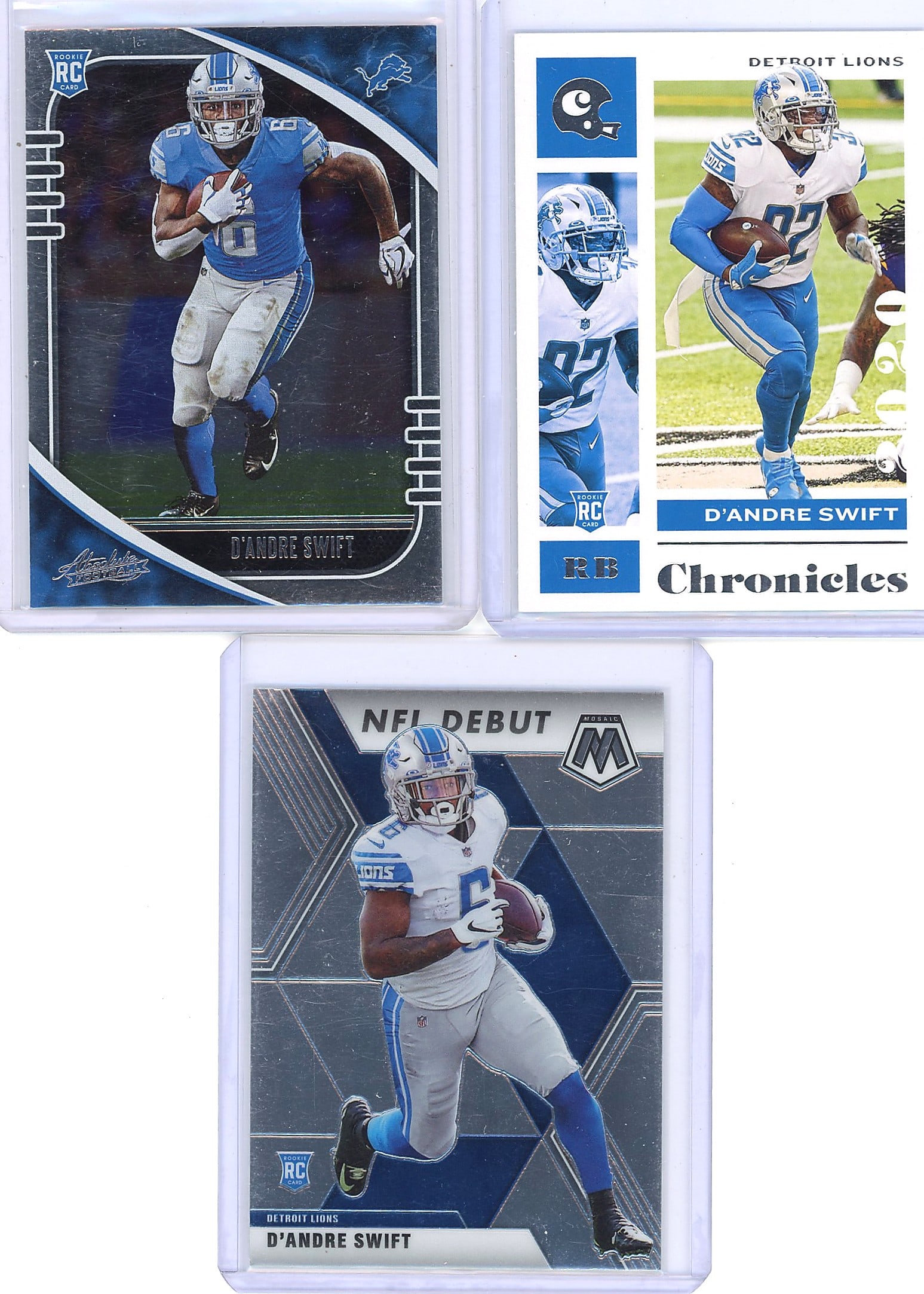2020 Panini D'Andre Swift Rookie Card Lot: This lot contains three D'Andre Swift rookie cards from 2020 Panini releases: a 2020 Panini Absolute Football #124 Running Back card (blue jersey), a 2020 Panini Chronicles card #32, and a 2020 Panini
