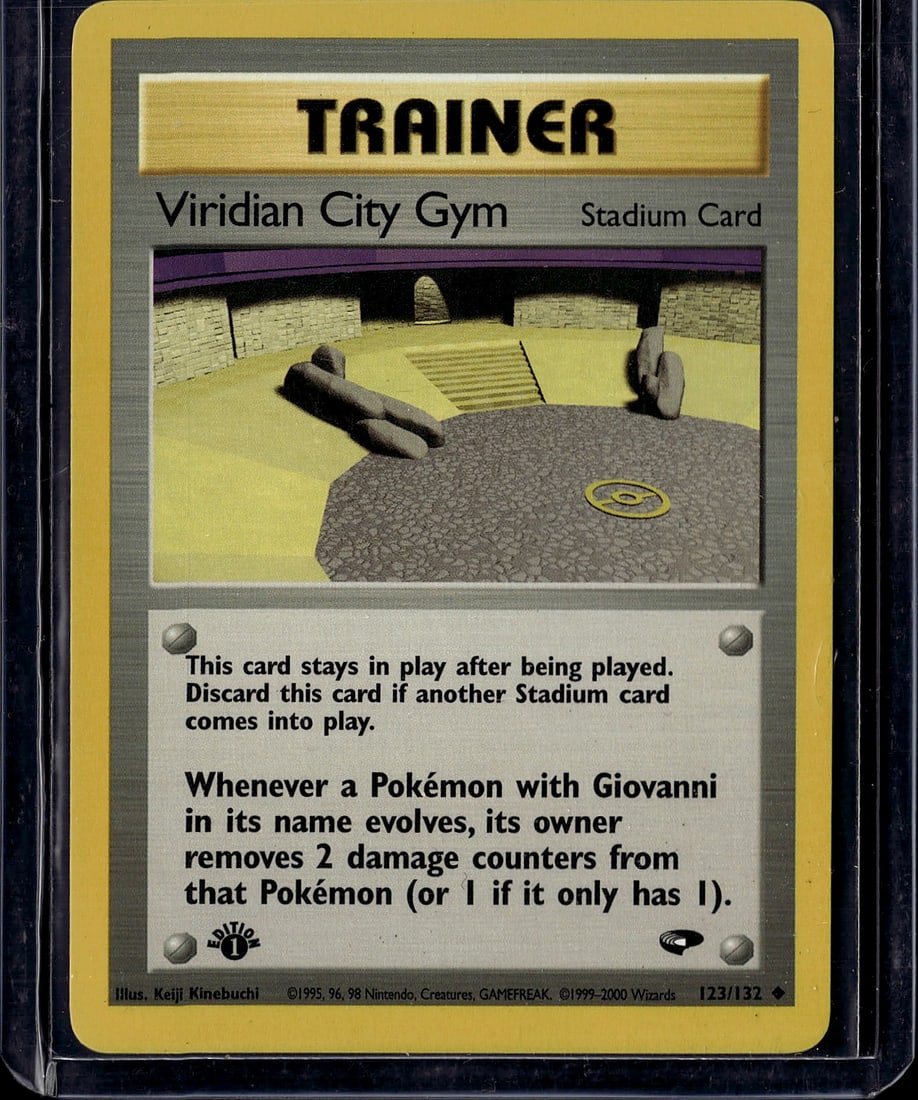 Viridian City Gym Stadium Card 123/132 Pokemon: This is an original 1999 Pokemon Gym Heroes Stadium card featuring Viridian City Gym, card number 123/132. The card displays excellent imagery of the gym's interior with distinctive architectural elem