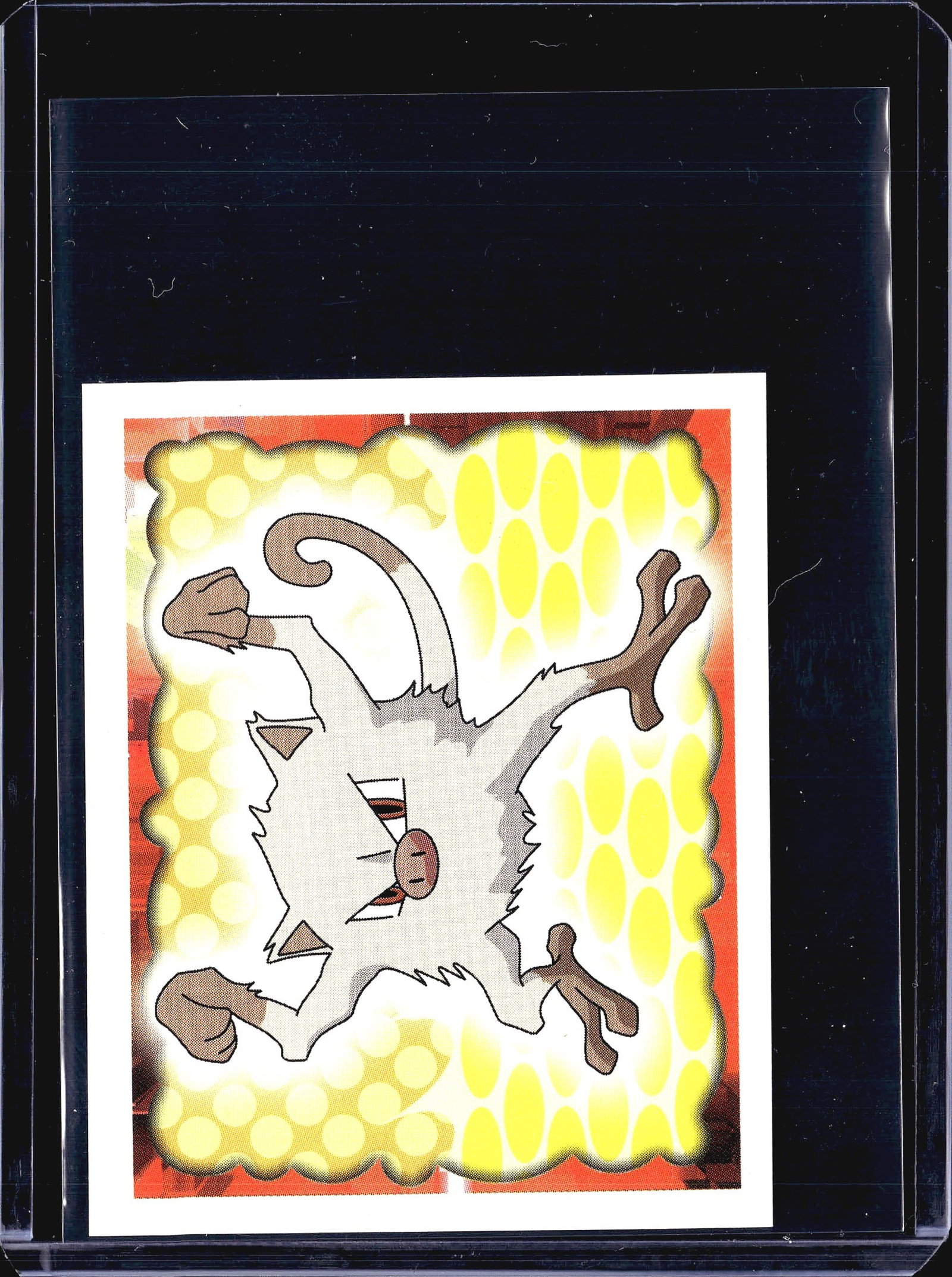 1999 Mankey Pokemon Merlin Topps Stickers Series: This is sticker #56 from the 1999 Merlin Collections officially licensed Pokemon sticker series. The front displays a white-bodied Pokemon in a dynamic action pose set against a vivid yellow and red