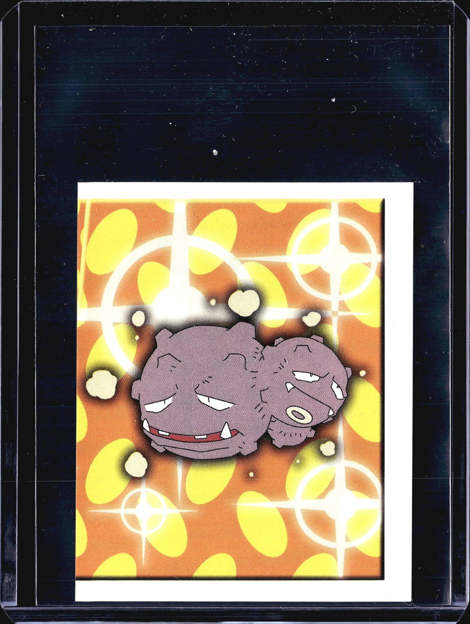 1999 Merlin Topps Pokemon Weezing Sticker #216: This is sticker #216 from the 1999 Merlin Pokemon Collection sticker series, featuring Weezing - the Poison-type dual-headed Pokemon. The front displays Weezing against an orange and yellow oval-patte