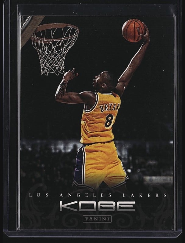 2012-13 Panini Kobe Anthology #14 Kobe Bryant: This is a 1997 Panini Kobe Bryant #14 basketball card from the Kobe set, depicting the Los Angeles Lakers legend in his iconic yellow jersey shooting a basketball. The card features Bryant's name and