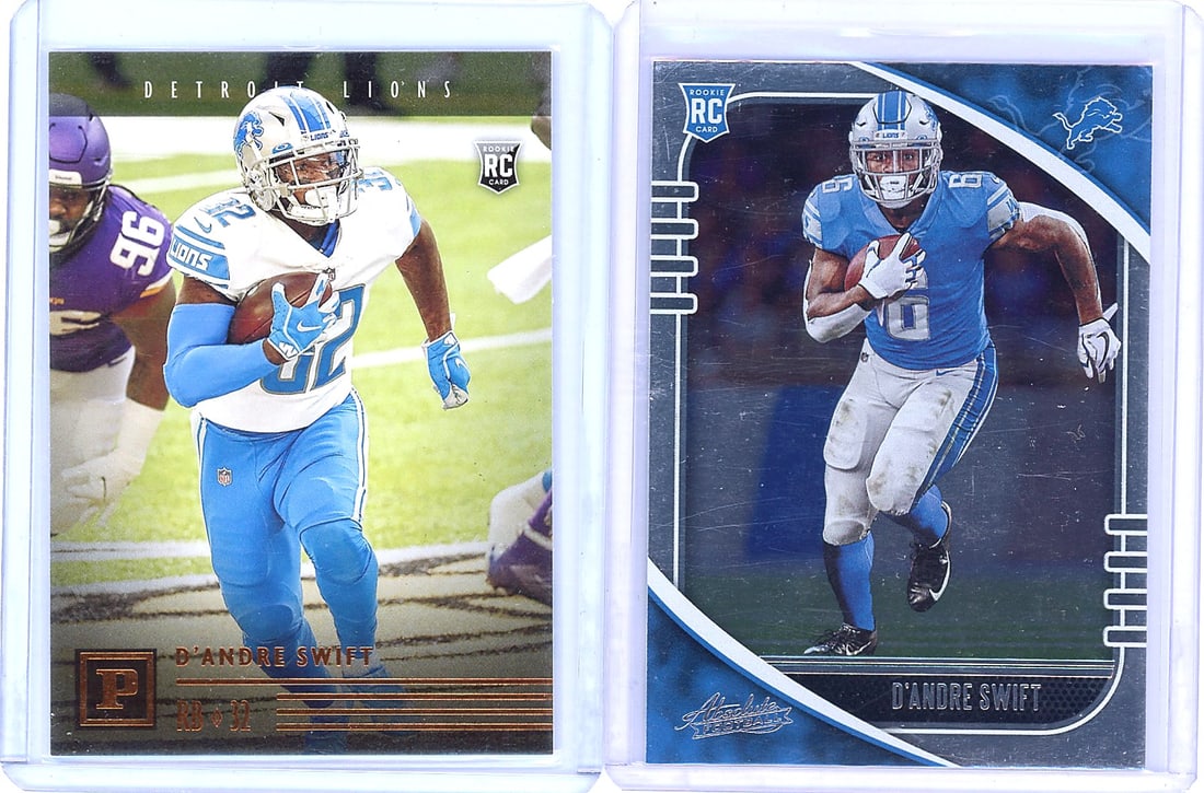2020 Panini Chronicles D'Andre Swift PA-10: Lot of two D'Andre Swift cards from 2020 Panini Chronicles and Absolute Football sets. Includes card PA-10 (Running Back #32, born January 14, 1999, drafted 2020 35th overall) and card #124 (Rookie RC