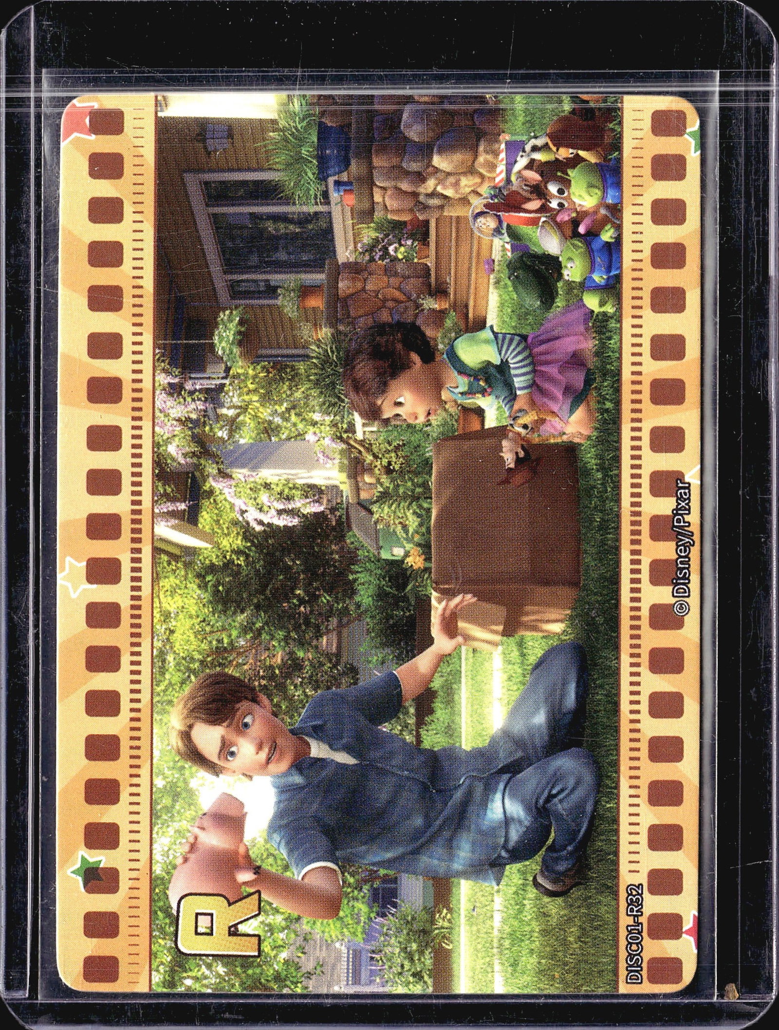 2023 Card.Fun Genesis Disney/Pixar Andy: This Disney/Pixar collectible trading card features Andy from the beloved Toy Story franchise, card number DISC01-R32. The card showcases a vibrant scene from the film set in a backyard, with Andy in 