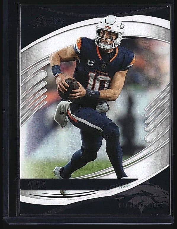 2025 Panini Absolute Bo Nix #65 Quarterback: 2025 Panini Absolute Football #65 Bo Nix rookie card featuring the quarterback in Chicago Bears navy uniform. Raw single in mint condition. Card displays sharp focus and vibrant color with clean