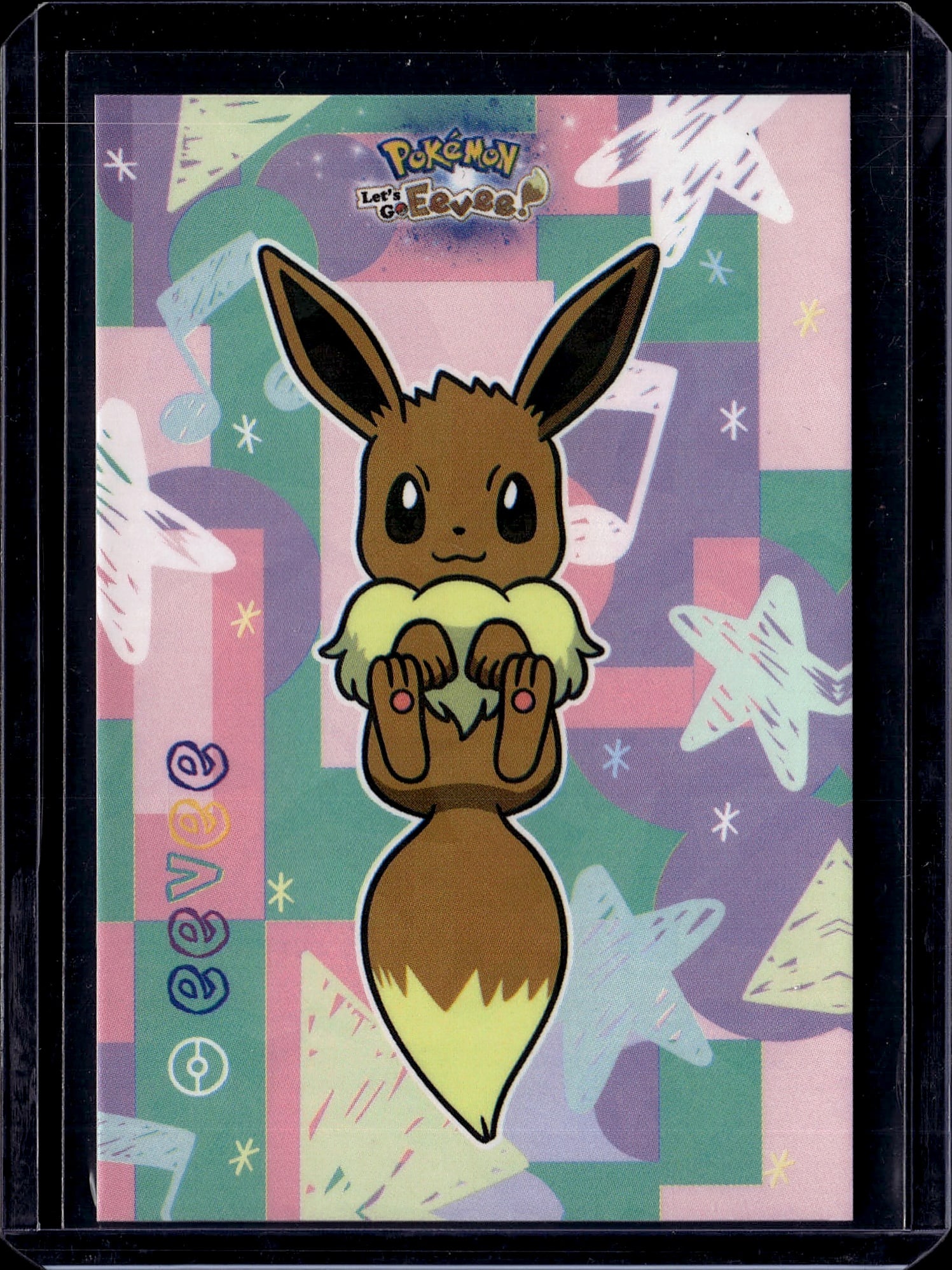 Pokemon Let's Go Eevee Official Card - Eevee: This is an official Pokemon Let's Go Eevee promotional card or merchandise item featuring the iconic Eevee character in its classic brown and cream coloring. The artwork showcases Eevee in a cheerful