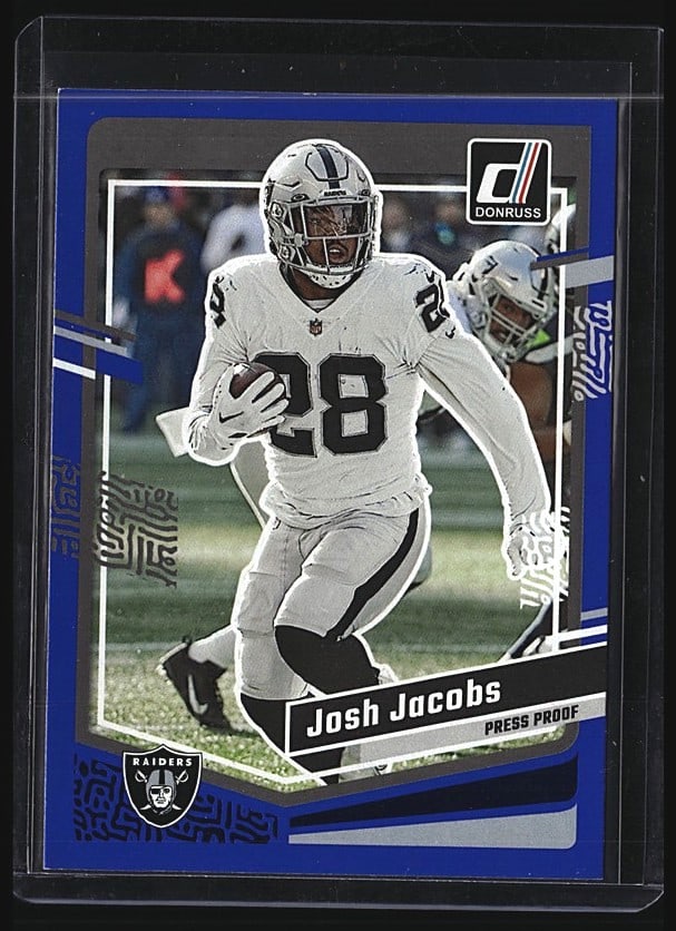 2022 Panini Donruss Josh Jacobs #178 Raiders: 2022 Panini Donruss Josh Jacobs #178 raw football card. Features the Las Vegas Raiders running back in white uniform during game action. Card displays the player name, position, team logo, and career
