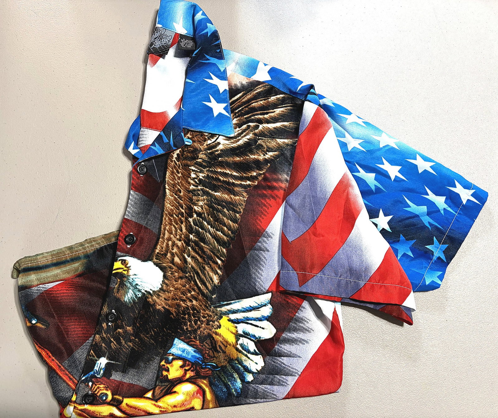 American Flag Bald Eagle Patriotic USA Button-Up: This is a vibrant all-over print button-up shirt featuring a bold patriotic American design. The fabric is covered with a large bald eagle in flight set against a full American flag backdrop with red
