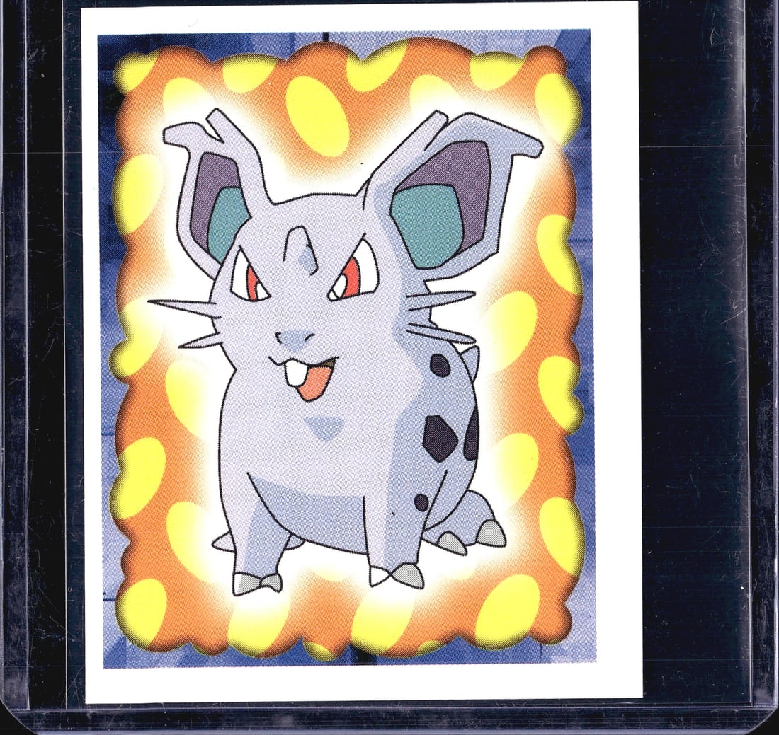 1999 Merlin Topps Pokemon Sticker Collection: This is sticker #29 from the 1999 Merlin Pokemon Sticker Collection, featuring Nidoran set against a dynamic orange and yellow glowing border on a blue background. Merlin Collections was a Nintendo-li