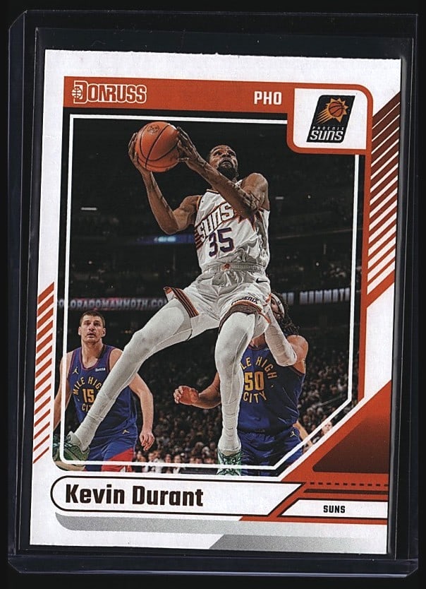 2024 Panini Donruss Kevin Durant #54 Basketball: 2024 Panini Donruss Basketball Kevin Durant card #54 featuring the Phoenix Suns star in action. This is a raw single in mint condition showing Durant shooting the basketball during game action. The