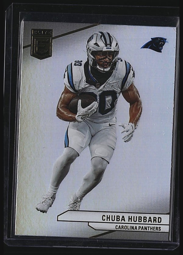 2024 Panini Donruss Elite #73 Chuba Hubbard: 2024 Panini Donruss Elite Football card #73 featuring Chuba Hubbard of the Carolina Panthers. Raw single in mint condition. The card displays Hubbard in his Panthers white uniform with the team logo v
