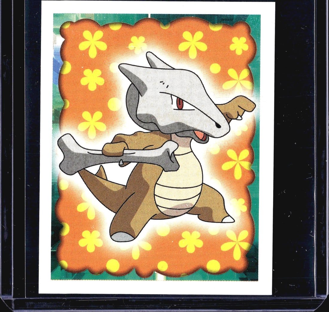1999 Merlin Pokemon Sticker #105 Marowak Holo: This is sticker #105 from the 1999 Merlin Collections Pokemon sticker series, featuring Marowak, the Bone Keeper Pokemon. The front displays a vibrant holographic foil design with an orange