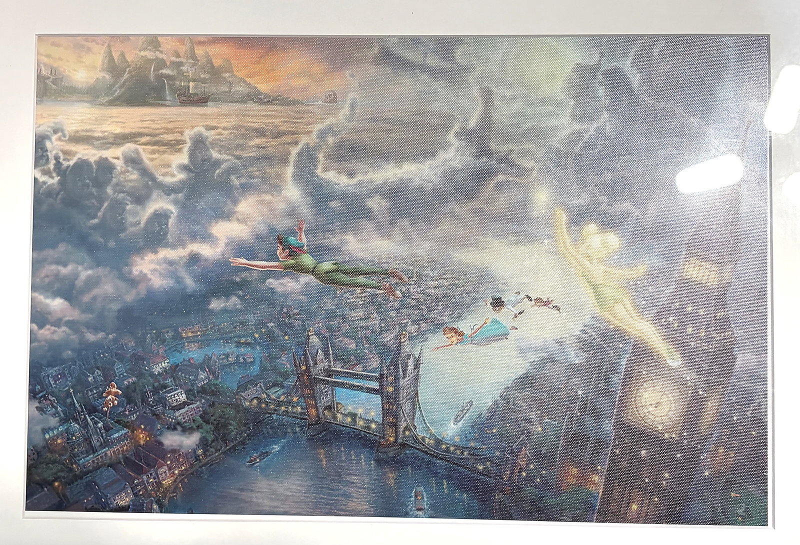 Thomas Kinkade Disney Tinkerbell Peter Pan Fly: This vibrant Disney-themed art print depicts the iconic scene from Peter Pan, featuring Peter Pan, Wendy, and the Darling children soaring above London alongside the glowing Tinker Bell. In the