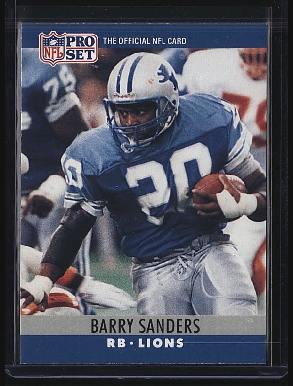 1990 Pro Set Barry Sanders #102 Football Card: 1989 Pro Set Barry Sanders #102 running back card featuring the Detroit Lions. This raw single shows Sanders in his iconic blue Lions uniform, card number 102. The card displays typical wear consisten