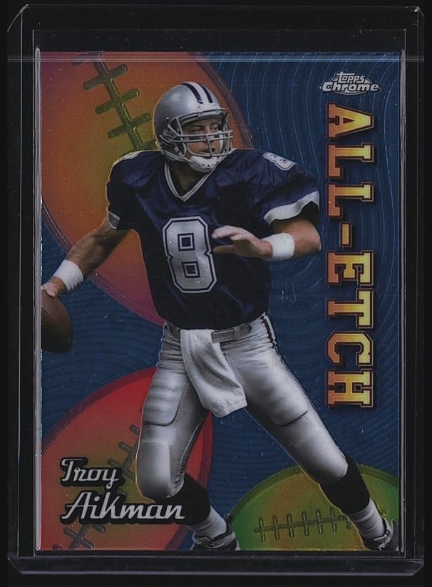 1999 Topps Chrome Troy Aikman #8 Dallas Cowboys: 1999 Topps Chrome #8 Troy Aikman of the Dallas Cowboys. This raw single features the Hall of Famer quarterback in a dynamic action pose wearing his iconic Cowboys uniform with number 8. The card