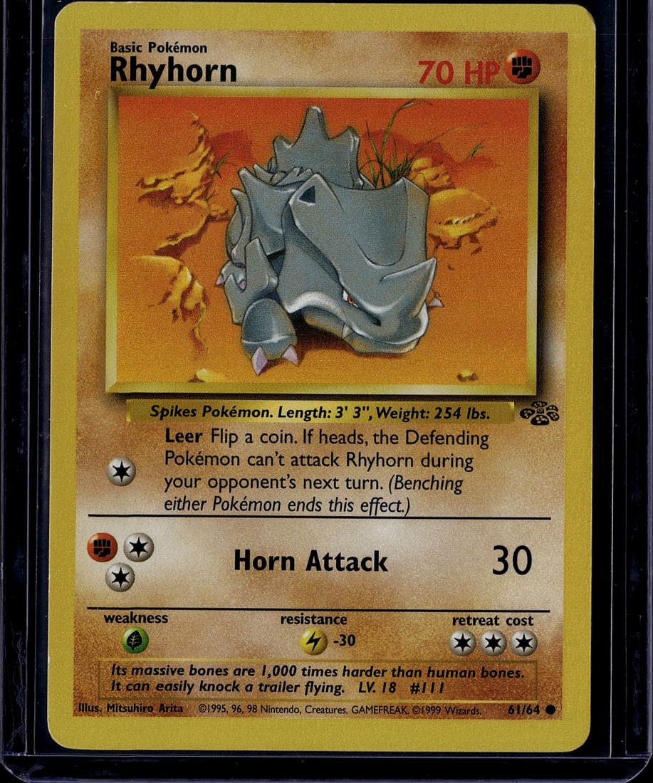 1999 Pokemon Base Set Rhyhorn #61/64 Classic TCG: This is an original 1999 Pokemon Trading Card Game Base Set Rhyhorn card (61/64), featuring the iconic Spikes Pokemon with 70 HP and the famous "Leer" ability. The card showcases excellent artwork