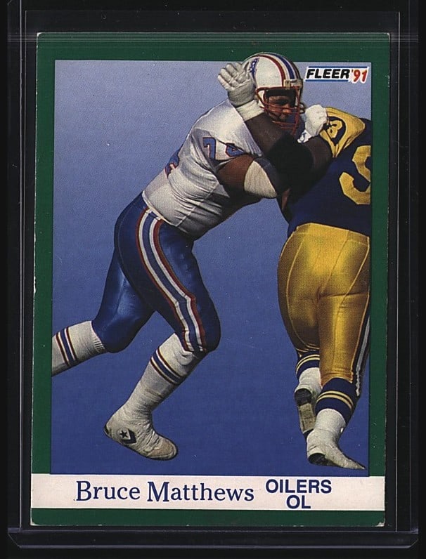 1991 Fleer Bruce Matthews #67 Football Card Near: 1991 Fleer Bruce Matthews #67 offensive lineman card for the Houston Oilers. This raw single features Matthews in action, showcasing the classic Fleer design of the early 1990s with green border frami