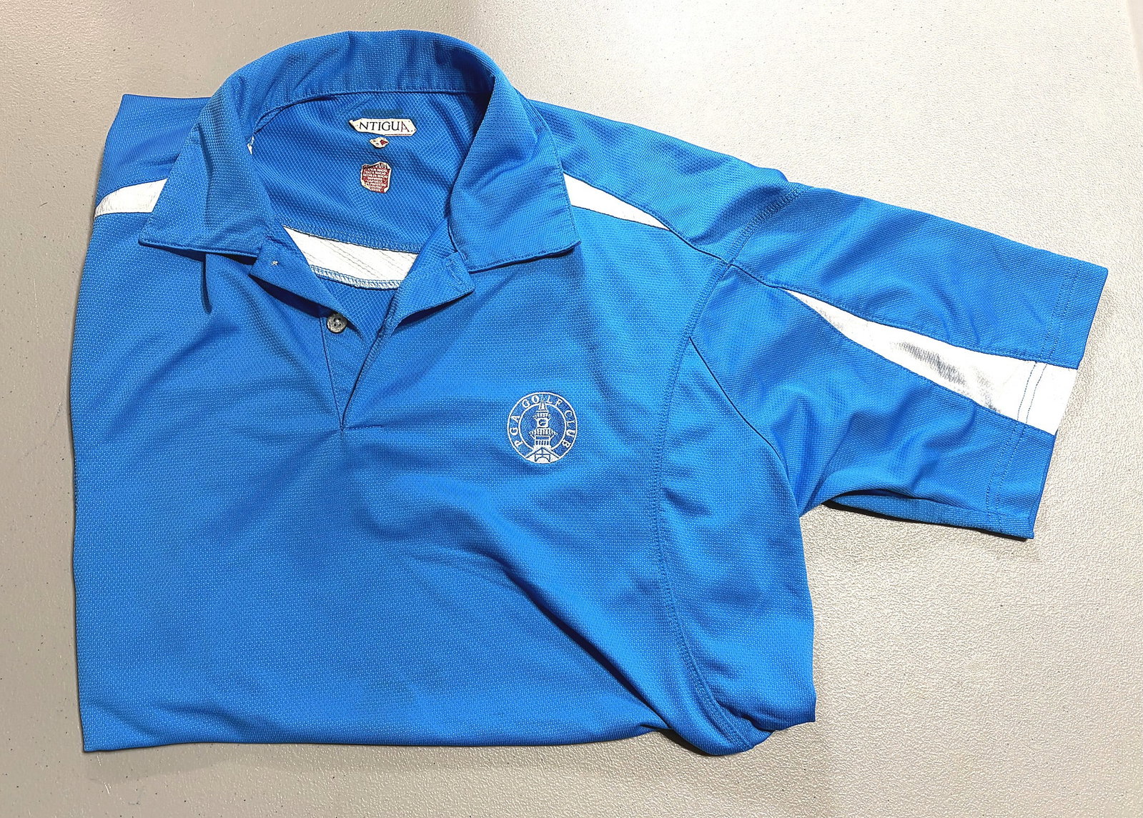 Antigua Philadelphia 76ers NBA Licensed Golf: This vibrant royal blue polo shirt is branded with an embroidered PGA Golf Club logo on the left chest. Made by Antigua, a well-known manufacturer of licensed sports and golf apparel, the shirt