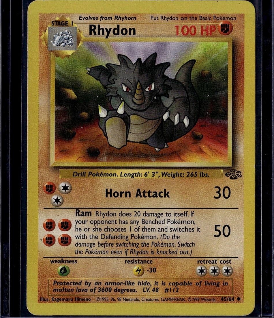 Rhydon Base Set 45/64 Pokemon Card 1999 Wizards: This is an original 1999 Pokemon Base Set Rhydon card (#45/64) published by Wizards of the Coast. The card features Stage 1 evolution artwork by Kagemaru Himeno, depicting the Drill Pokemon with its