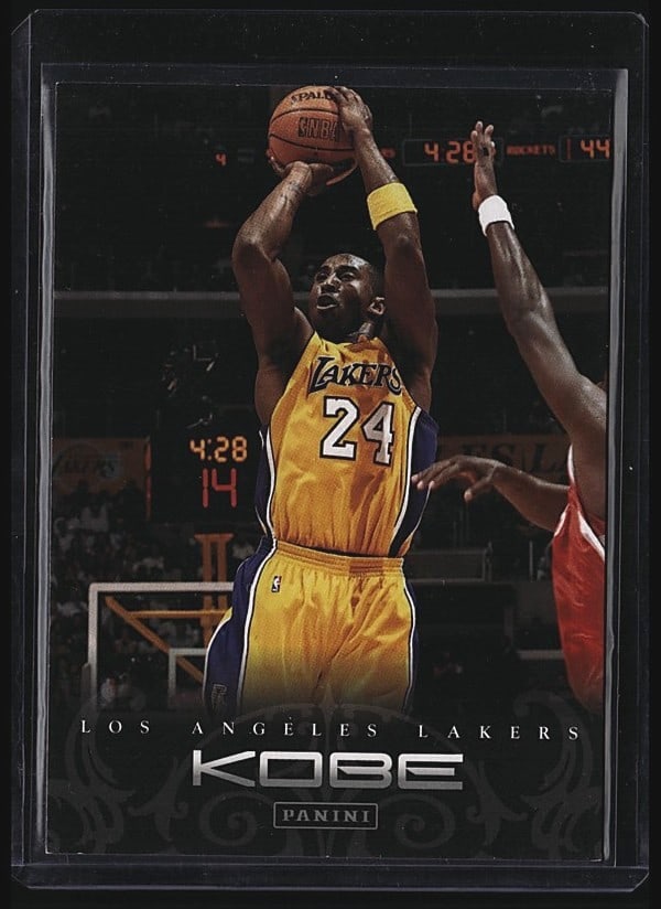 2012 Panini Kobe Anthology #140 Kobe Bryant: 2009 Panini Kobe card #140 featuring Kobe Bryant in his iconic Los Angeles Lakers yellow jersey. The card displays Bryant taking a jump shot during game action. Card back includes full player stats