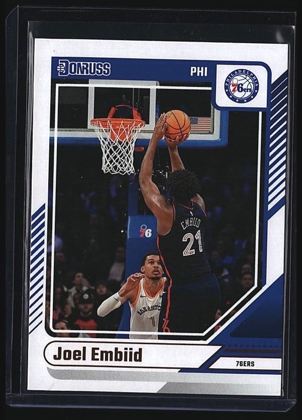 2024 Panini Donruss Joel Embiid #28 Basketball: 2024 Panini Donruss Basketball card featuring Joel Embiid of the Philadelphia 76ers, card #28. This raw single captures Embiid in action shooting over a defender. The card displays sharp focus and