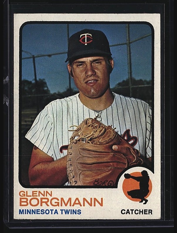 1973 Topps Glenn Borgmann #284 Baseball Card: 1982 Topps Glenn Borgmann baseball card #284 featuring the Minnesota Twins catcher. The card shows Borgmann in his Twins pinstriped uniform holding a baseball glove, photographed in a dugout setting.