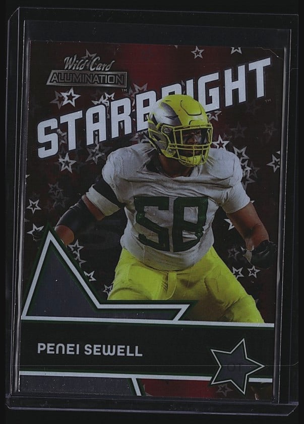 2021 Wild Card Alumination Starbright SB-29: Raw sports single featuring Penei Sewell from the 2021 Wild Card Starrbright set, card number SB-29. The card displays Sewell in Oregon Ducks yellow and white uniform in an athletic pose. This is an