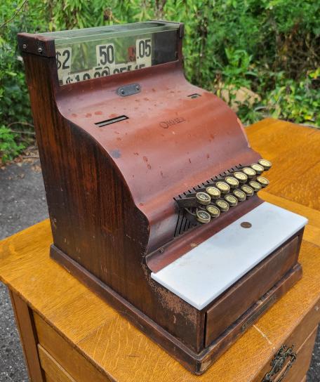 Antique Ohmer Cash Register: Description: This lot includes an antique Ohmer cash register. Register is made of wood grain painted metal. No keys. Condition: Register is in beautiful original antique condition. Fully Functional, 