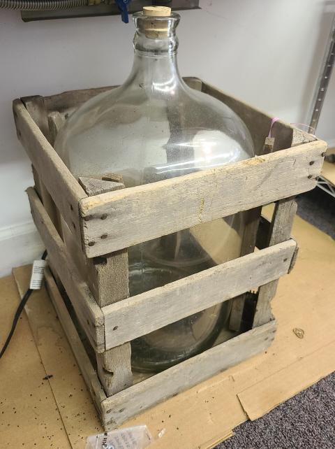 Antique 5G. Glass Carboy w/ Crate: Description: This lot includes an antique five gallon glass carboy with wood crate. Condition: Overall good condition, appears to be without any chips or cracks. Shippable Item: Contact Auctioneer.Mea