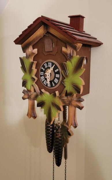 30 Hour German CuChoo Clock: Manufacturer: Unknown Features & Details: -Shingled roof -2 Pine cone weights Measurements: 7"L x 4"W x 10"H Condition: Clock is in good condition with expected wear. Clock was running during testing 
