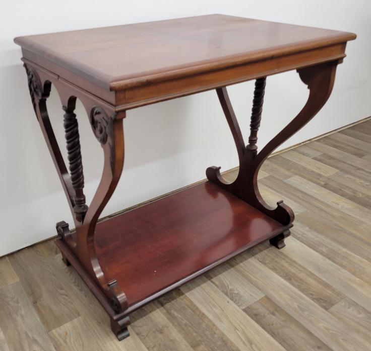 Antique Lyre Style Mahogany Side Table: Description: This lot includes a solid mahogany side table with lyre style legs on either side. The table appears to date to the 20th century. Condition: Minor expected Surface wear associated with ag