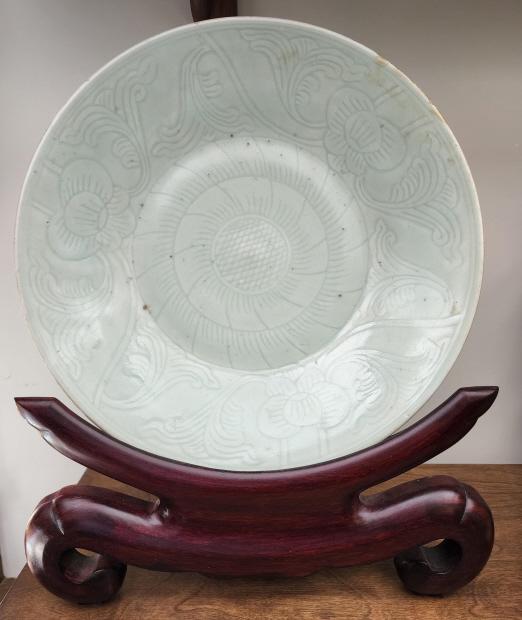 Chinese Celadon Porcelain Charger: Description: This lot includes a Chinese celadon charger made of glazed porcelain. The piece is not signed but appears to hold some age. See photos for details. Condition: Minor expected surface wear