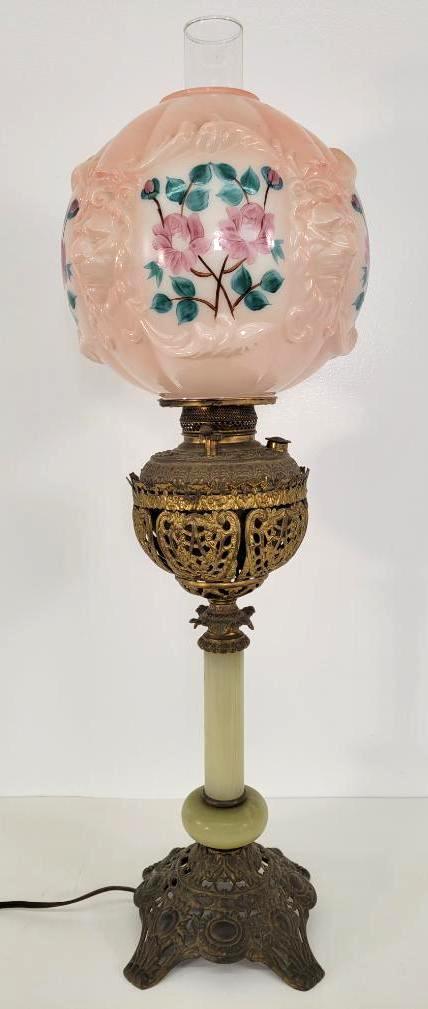19C. Brass & Onyx Banquet Lamp: Description: This lot includes a 19th century brass and onyx banquet lamp. Lamp features a pierced brass and onyx base with a pink painted glass globe. Lamp has been converted and is functional. Condi