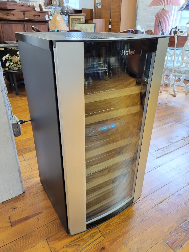 Haier Wine Cellar: Description: This lot includes a wine cellar made by Haier. Model #HVZ040ABH5SBJ Condition: Wine cellar powers on and condenser gets hot, however the unit does not appear to get cool. Measurements: 21