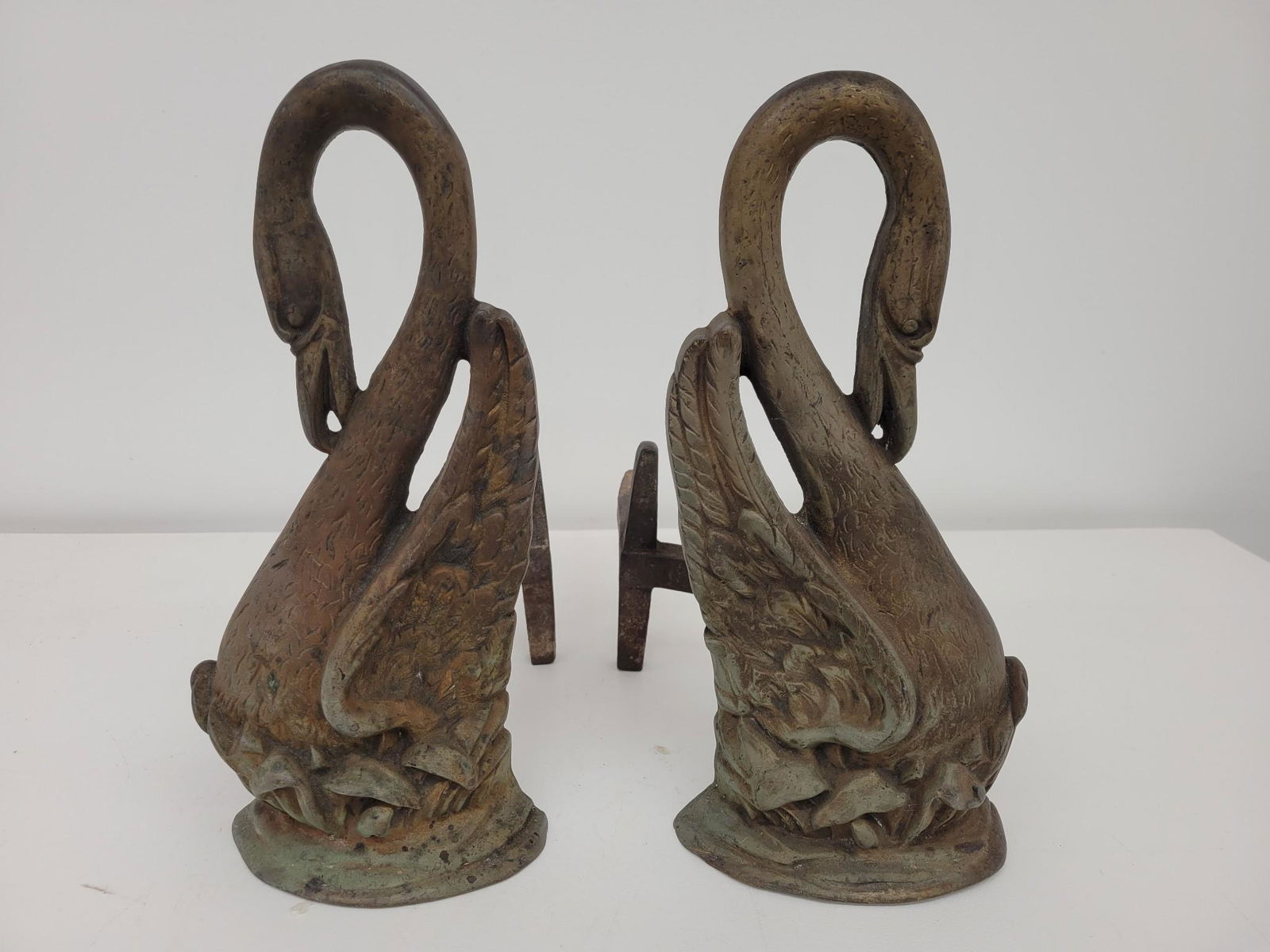 Pair of Bradley & Hubbard Cast Iron Andirons: Description: This lot includes a pair of original late 19th century cast iron andirons manufactured by Bradley & Hubbard. Marked on the arms and in the form of a swan. This piece comes directly out of