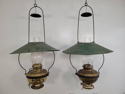 (2) Two Antique Brass Country Store Oil Lamps: Both lamps include the original metal hanging frame with a large tin shade. Includes a Bradley & Hubbard No. 96 & The Empress No. 3. Both lamps are missing the burners Measurements: 21"W x 41"H