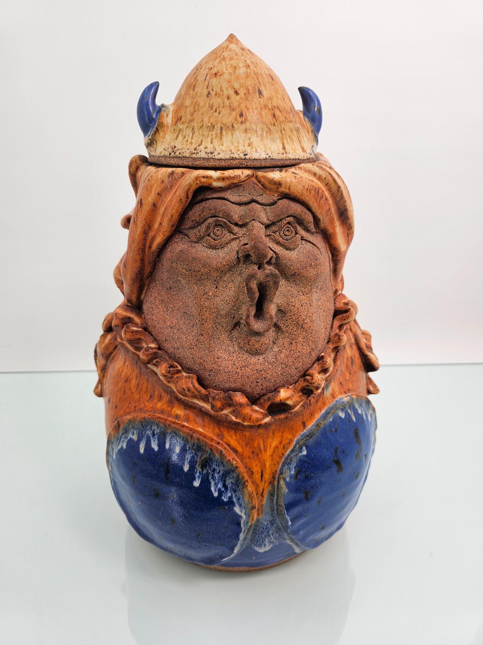 Thomas Reece Pottery PA Character Jar - Viking: Jar is signed on the bottom "Reece 1981" the mark for Thomas Reece Pottery in Newfoundland PA. The covered jar depicts a expressive figure of a Viking Women glazed in blue and tan colors. No damage as