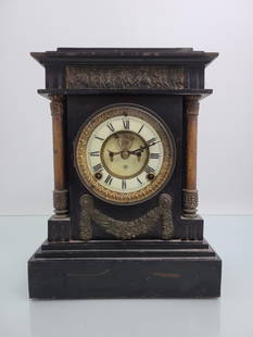 Ansonia Cast Iron Mantle Clock: This lot includes a enameled case iron mantle clock by the Ansonia Clock Co. The clock features a uranium dials, applied decoration and open escapement dial. The back plate of the clock was replaced a