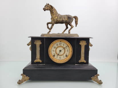 Ansonia Cast Iron Horse Mantle Clock: This lot includes an enameled cast iron mantle clock by the Ansonia Clock Co. The clock features a horse clock topper and horse busts on either side. Includes pendulum but no key, movement appears to