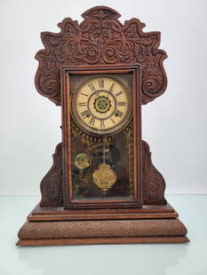 Waterbury Clock Co Gingerbread Mantle Clock: This lot includes a gingerbread style mantle clock made by the Waterbury Clock Company. The original paper label is still visible on the reverse, finish is original but alligatored throughout. Include