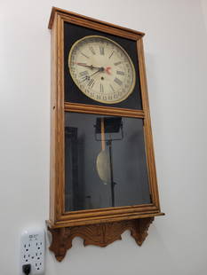 Gilbert Store Regulator Wall Clock w/ Calendar: This lot includes a turn of the century store regulator wall clock made by the Gilbert Clock Co. The clock features a calendar feature on the dial. Includes the original pendulum but no key. All cloc