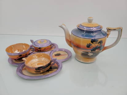 Nippon Orange Luster Ware Tea Set: Signed on the bottom, vintage in age. Includes a matching tray to hold the teacups and sugar & creamer. Set is missing 1 teacup but appears to be without any notable damage.