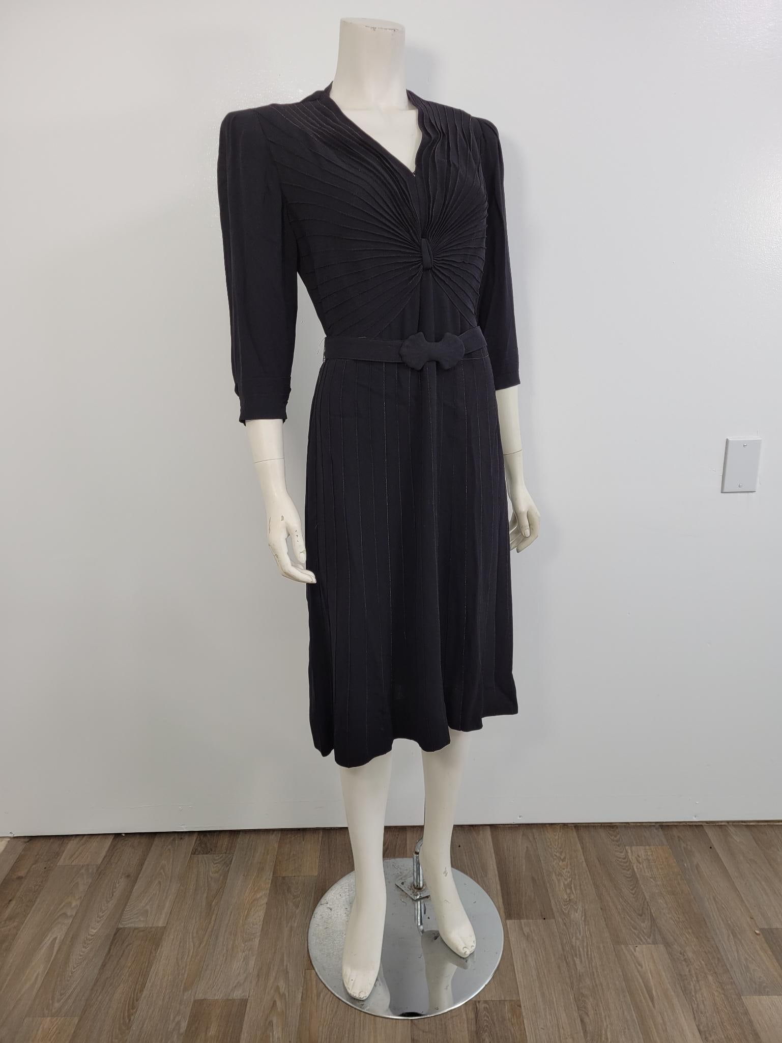 Black Vintage Cocktail Dress W/ Bow Belt: Description: Black vintage cocktail dress with bow belt. Appears to be from the 70s, has no labels. Was clipped to fit dress form (see photos) no rips or stains Measurements: Shoulders 15" waist 38" s