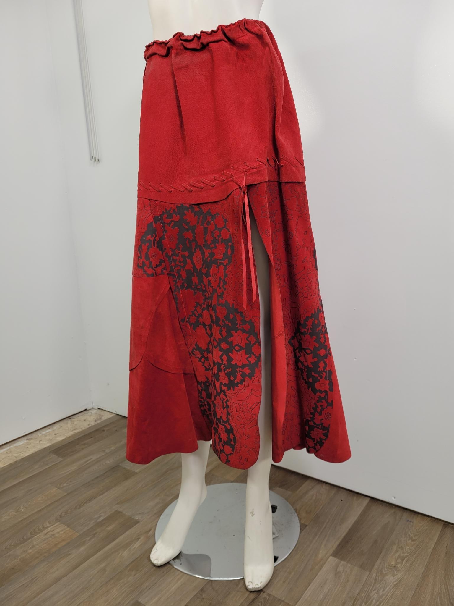 Italian Made Vintage Red Suede Skirt: Description: Italian made vintage red suede patchwork skirt. Some discoloration on waist and a few spots on body of skirt. (see photos) No label. Measurements: 40" elastic waist