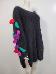 Black Mohair Sweater With Pom Poms: Description: Black mohair sweater with pom accents on sleeve. Has a small hole in the front(see photos) No labelsMeasurements: XXL